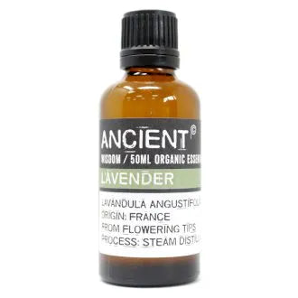 Amber glass bottle labeled 'Ancient Wisdom Organic Essential Oil Lavender 50ml,' origin France, made from flowering tips, steam distilled.