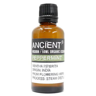 Amber glass bottle labeled 'Ancient Wisdom Organic Essential Oil Peppermint 50ml,' origin India, made from flowering herbs, steam distilled.
