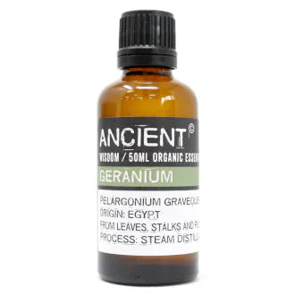 Amber glass bottle labeled 'Ancient Wisdom Organic Essential Oil Geranium 50ml,' origin Egypt, made from leaves, stalks, and flowers, steam distilled.