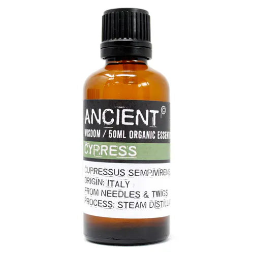 Amber glass bottle labeled 'Ancient Wisdom Organic Essential Oil Cypress 50ml,' origin Italy, made from needles and twigs, steam distilled.