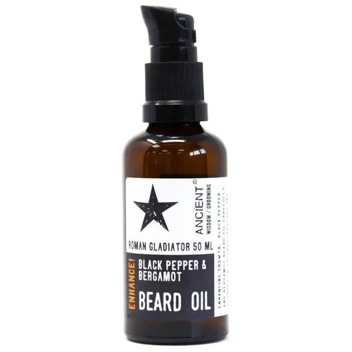 A brown 50ml glass bottle of Ancient Wisdom Roman Gladiator Beard Oil. The bottle has a black pump dispenser and a label with a black and white design and the text "Enhance!" and "Black Pepper & Bergamot". The bottle is photographed against a white background.
