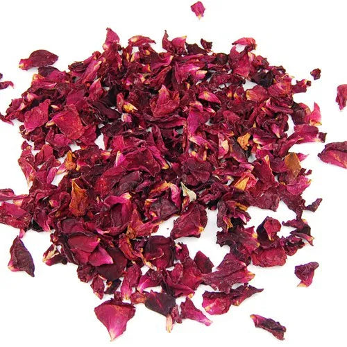 A pile of dried, red rose petals on a pure white background. The petals are a rich, dark red color with some brown tones, showing their textured and crumpled appearance.
