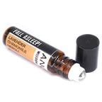 Open roll-on essential oil blend labeled 'Fall Asleep!' with lavender, chamomile, and neroli. Brown glass bottle with roller ball and black cap beside it.