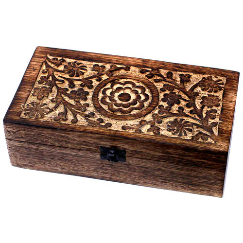 rectangular wooden box with a dark finish. The lid is adorned with intricate carved floral patterns, including a central circular medallion surrounded by a pattern of stylized flowers and leaves. A small black metal clasp is on the front, and the product is professionally photographed on a clean white background.